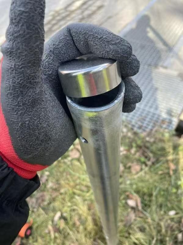 Galvanized steel cattle fence post set in the field